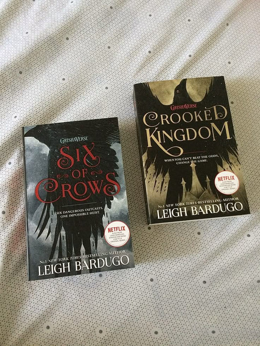 Two books, 'Six of Crows' and 'Crooked Kingdom', by Leigh Bardugo